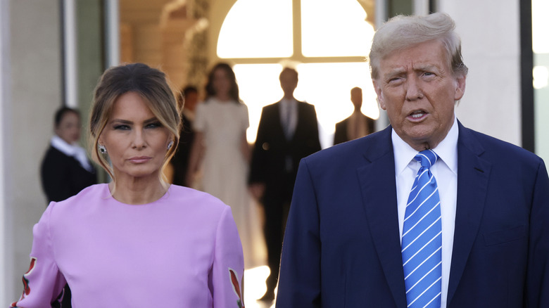 Melania Trump stands next to Donald