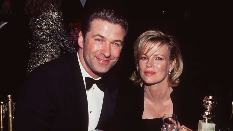 Alec Baldwin and Kim Basinger sit at a table in 1998