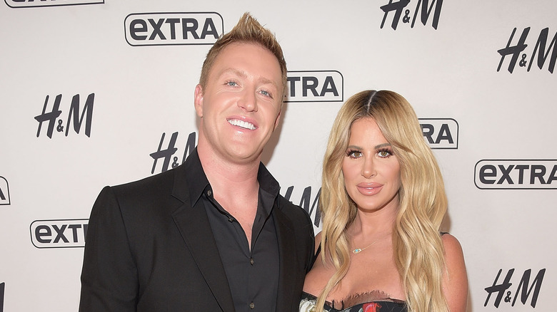 Kroy Biermann black suit Kim Zolciak floral dress