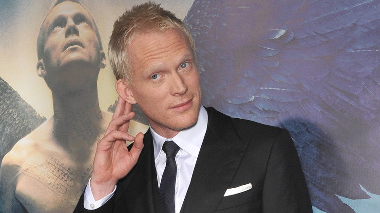 Paul Bettany holding his ear