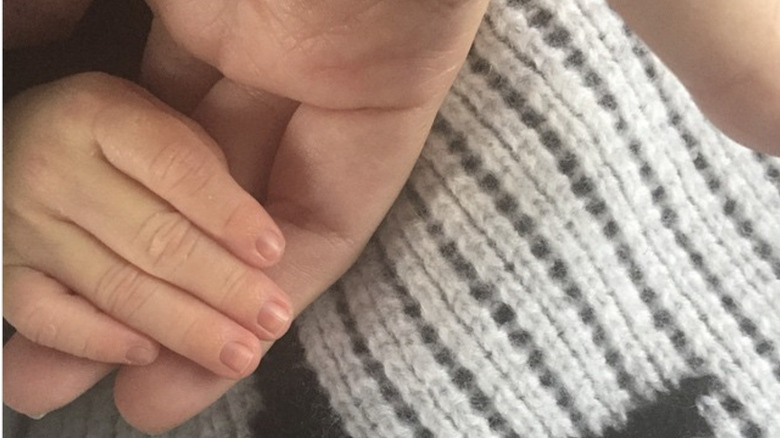 Kourtney Kardashian and baby Reign's hands