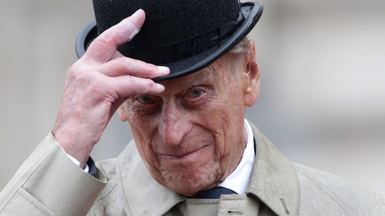 Prince Philip holding black top hat