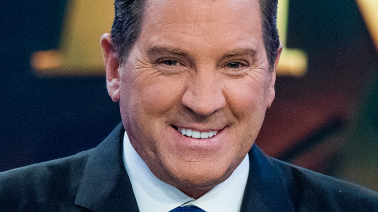 Eric Bolling grinning black suit