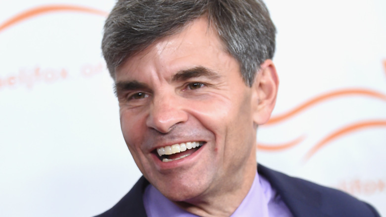 George Stephanopoulos laughing blue suit