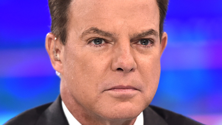 Shepard Smith wearing earpiece, looking stern