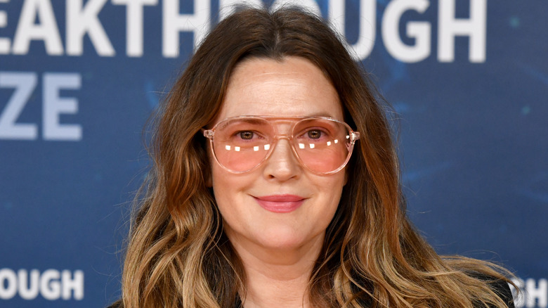 Drew Barrymore smiling with glasses on