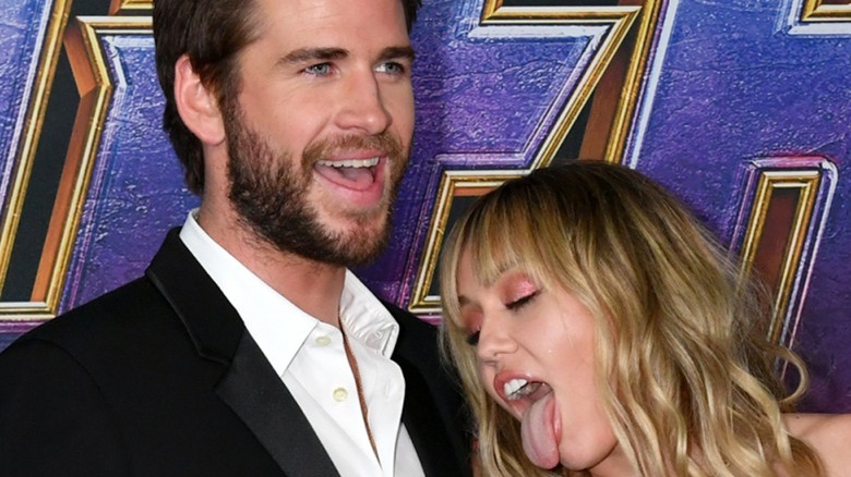 Miley Cyrus licks Liam Hemsworth