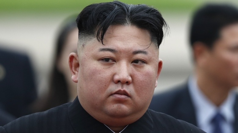 Kim Jong Un, his hair parted down the middle