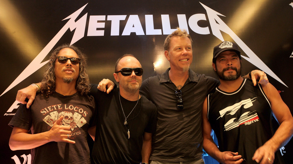 Kirk Hammett, Lars Ulrich, James Hetfield, and Robert Trujillo of Metallica posing together