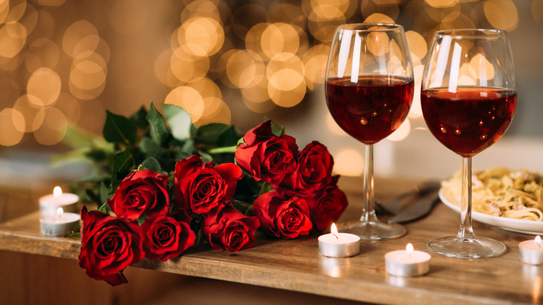 Glasses of wine next to roses