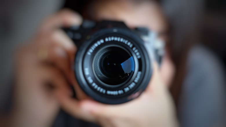 Soft focus of female photographer taking photo