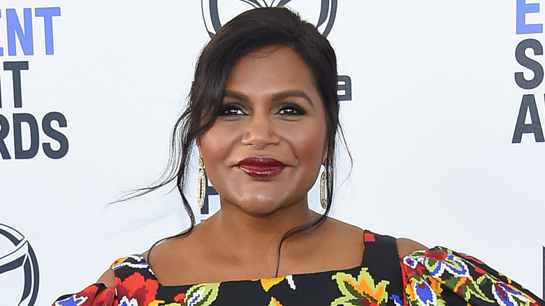 Mindy Kaling smiling, looking away