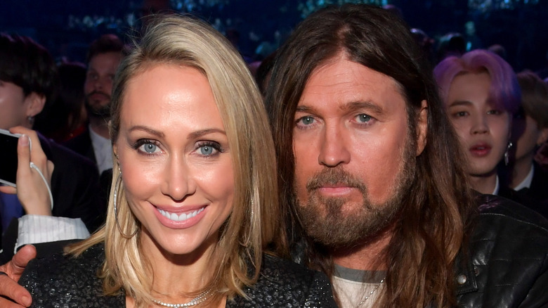 Tish smiling with Billy Ray Cyrus