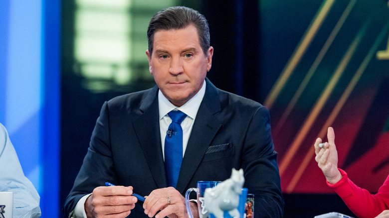 Eric Bolling behind anchor desk during filming of Fox News' The Five