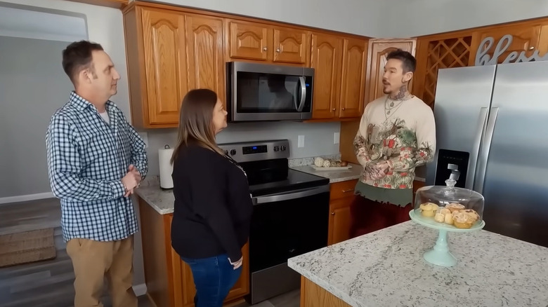 David Bromstad talking to couple in kitchen