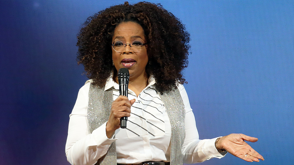 Oprah Winfrey speaking into a microphone 