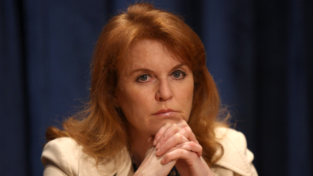 Sarah Ferguson looking stern, resting her chin on her folded hands 