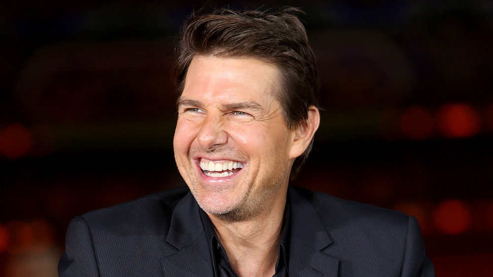 A very excited Tom Cruise smiling broadly 