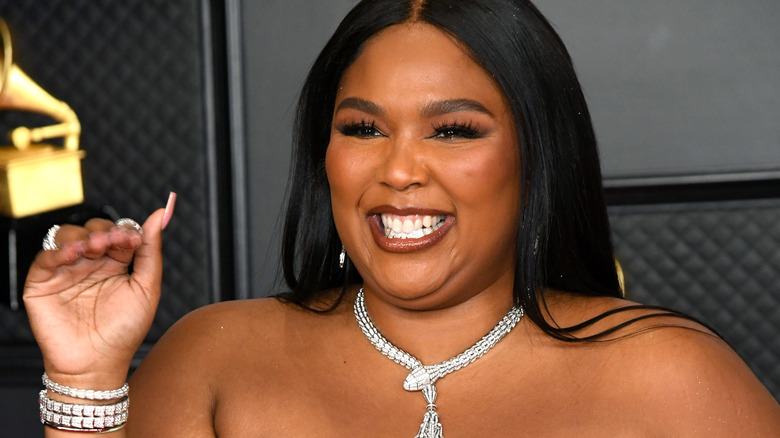 Lizzo smiling and waving 