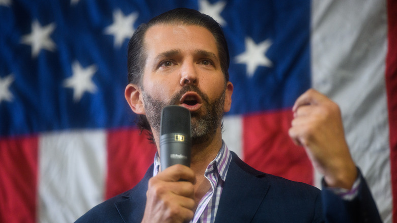 Donald Trump Jr. holds microphone