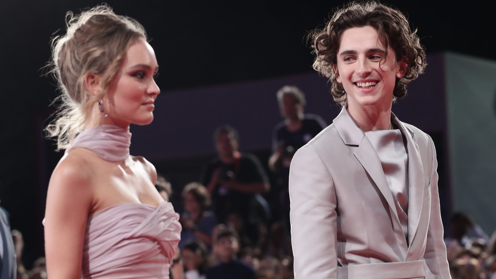 Timothée Chalamet smiling at Lily-Rose Depp