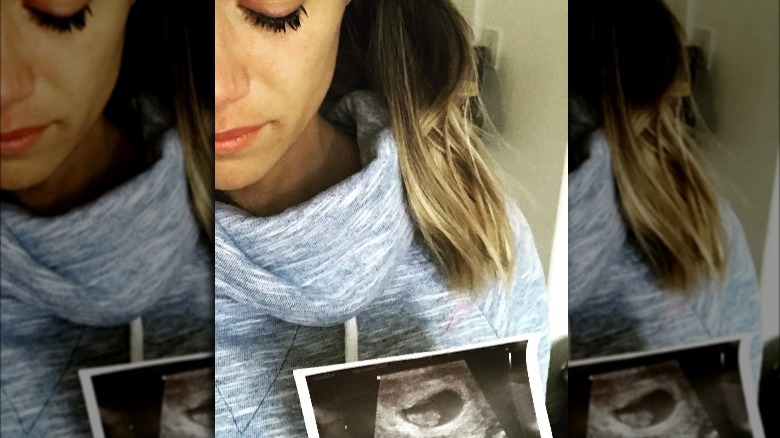 Jana Kramer holds up a sonogram