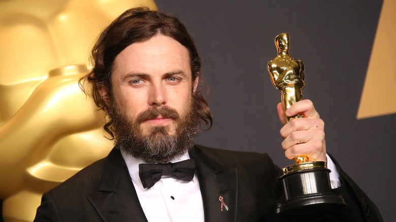 Casey Affleck holding an Oscar