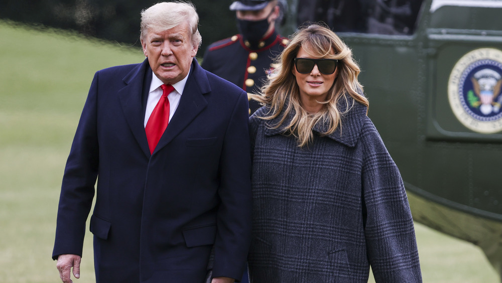 Donald and Melania Trump walking outside