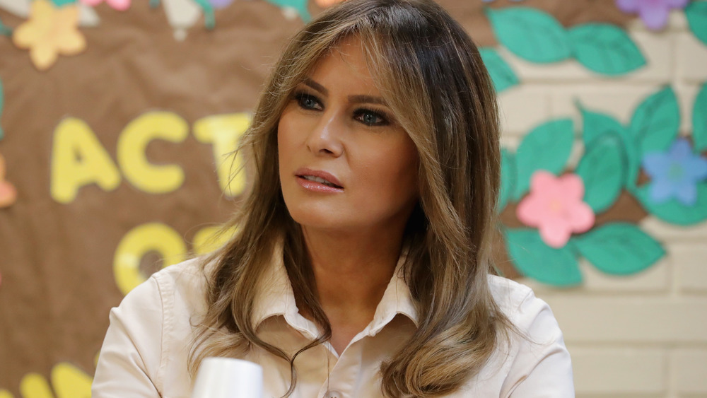 Melania Trump seated and looking away