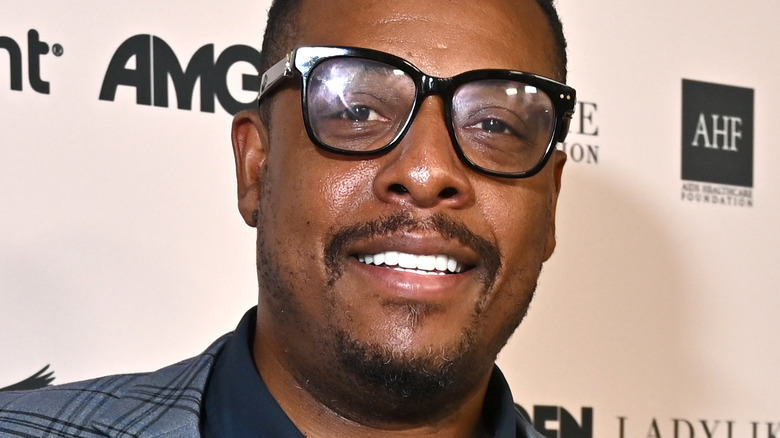 Paul Pierce wearing a plaid jacket and glasses