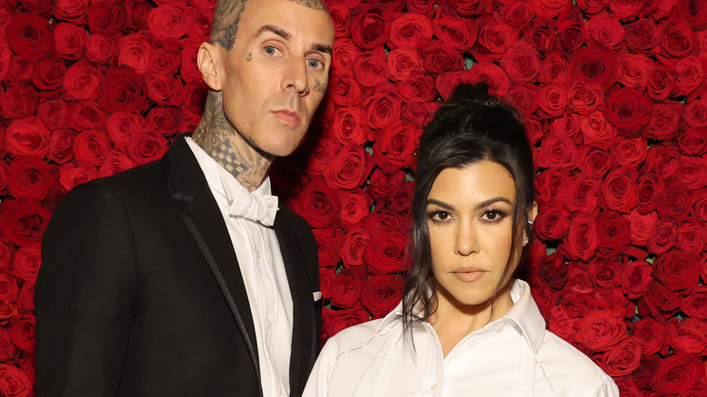 Travis Barker and Kourtney Kardashian posing