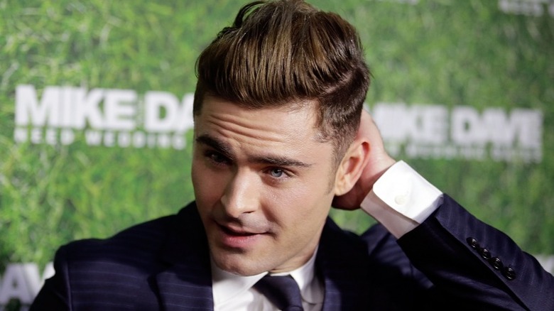 Zac Efron scratching his head