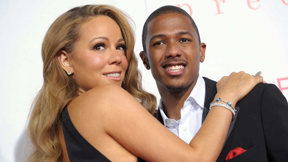 Mariah Carey and Nick Cannon, smiling with their arms around each other