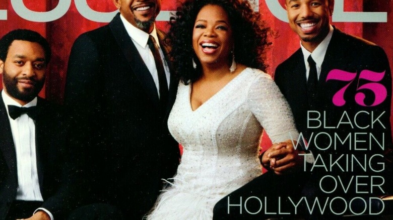 Oprah smiling in white feathered dress