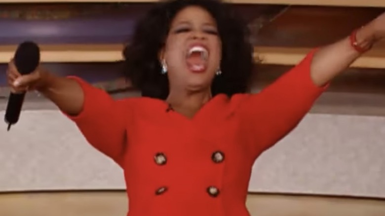 Oprah in red with microphone