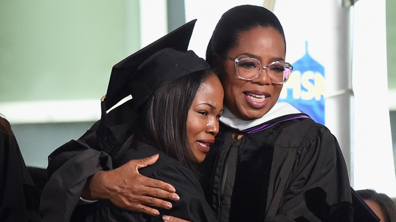 Oprah Winfrey hugging OWLAG graduate