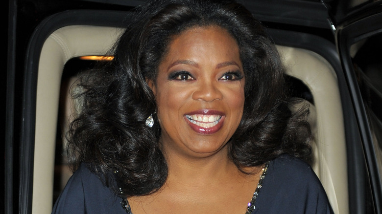 Oprah Winfrey smiling in navy top