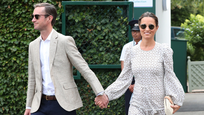 Pippa Middleton and James Matthews holding hands at Wimbledon.