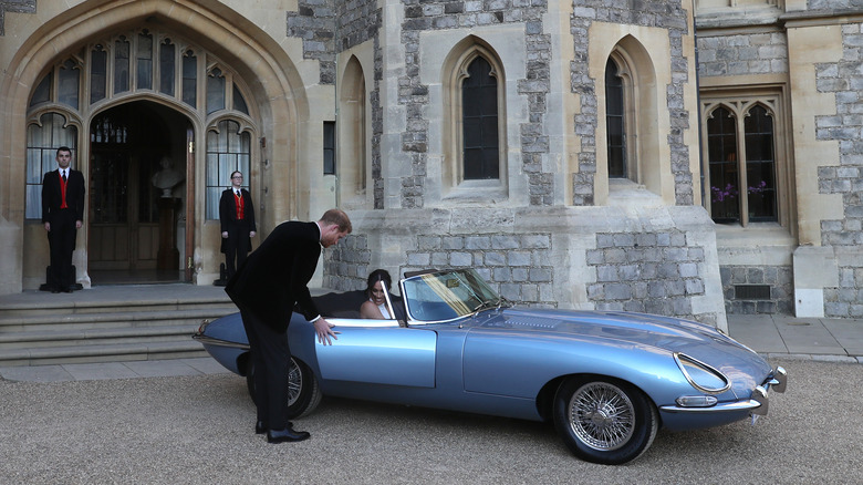 Prince Harry and Meghan Markle with a Jaguar