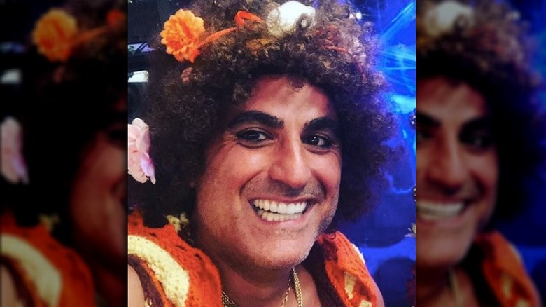 Reza Farahan smiling in Halloween costume