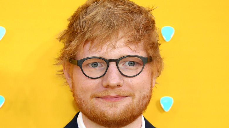 Ed Sheeran with glasses on looking serious