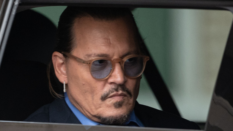 Johnny Depp looking angry in car