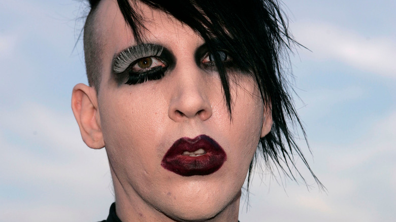 Marilyn Manson with heavy eye makeup and lipstick