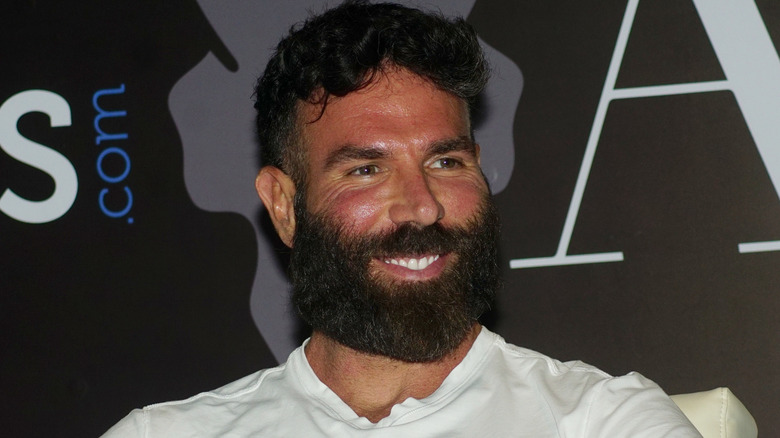 Dan Bilzerian smiling in white