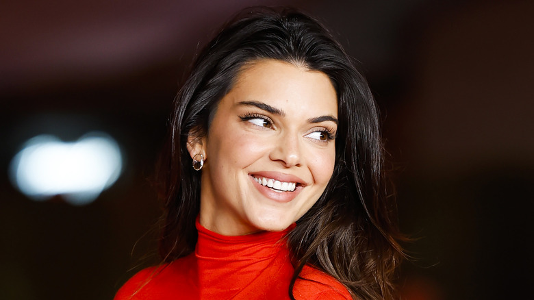 Kendall Jenner smiling in red