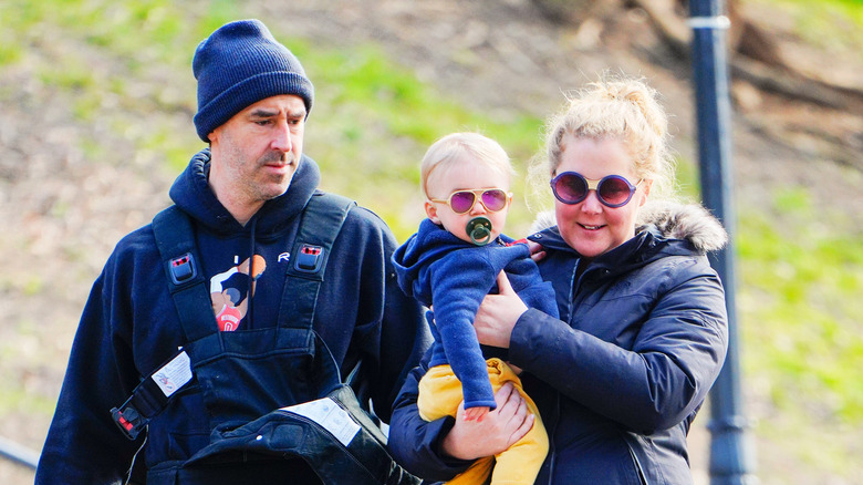 Amy Schumer and Chris Fischer walk their son