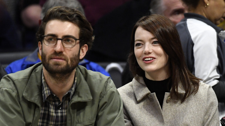 Dave McCary and Emma Stone watching NBA game