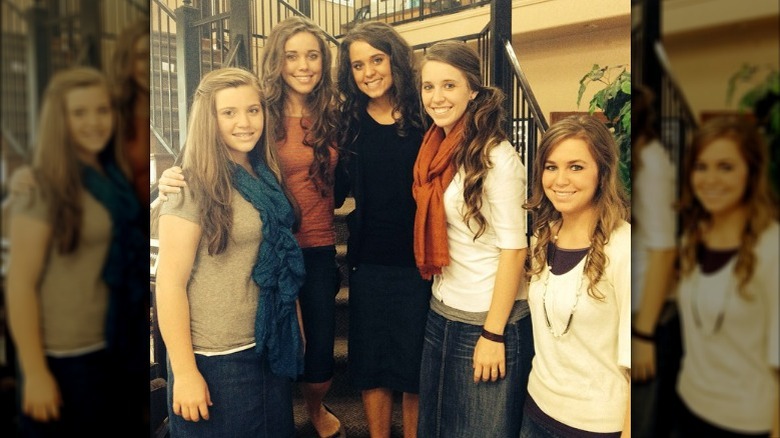 The Duggar sisters posing on stairs