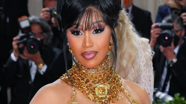 Cardi B pouting in gold