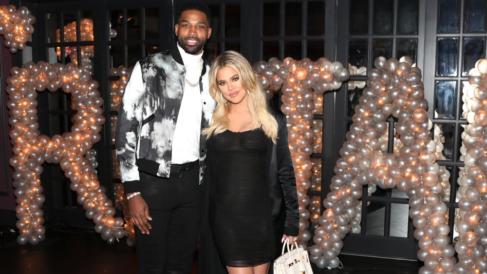 Khloe Kardashian and Tristan Thompson arm in arm